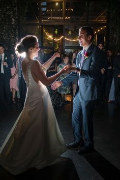 a bride and groom dancing at their wedding reception