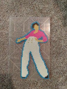 a piece of art that looks like a baseball player in pink and white pants on the ground