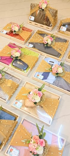 there are many pictures on the table with flowers in them and some cards laid out