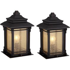 two black lanterns with one light on each side and the other off to the side