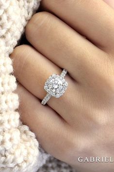 a woman's hand with a diamond ring on it