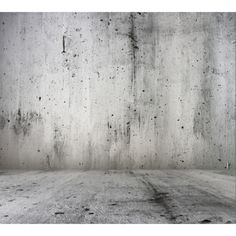 an empty room with concrete walls and floor