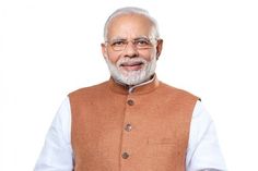 an old man wearing a brown vest and standing in front of a white wall with his hands on his hips