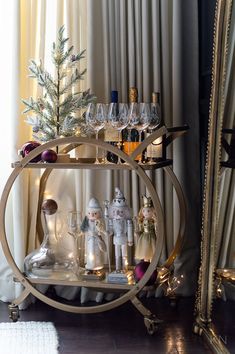 a shelf with wine glasses and figurines on it