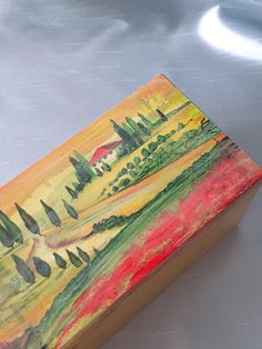 a painting on a wooden box sitting on a table