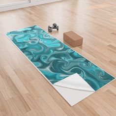 a yoga mat with blue swirls on it next to a block of brown blocks