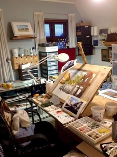 an artist's studio with easel, canvass and other art supplies