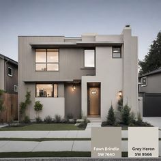 the exterior of a two story house with gray siding and white trim