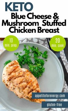 the keto blue cheese and mushroom stuffed chicken breast is on a plate with parsley