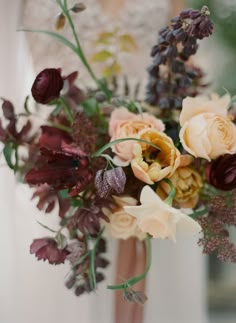 a bride holding a bouquet of flowers in her hands