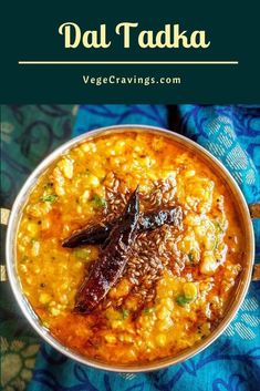 a bowl filled with food on top of a blue cloth and text that reads dal tada