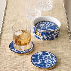 blue and white plates with glasses sitting on a table