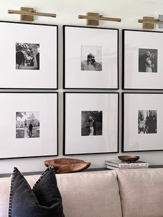 A large black and white gallery wall of frames filling the large space behind the couch. Symmetrical Gallery Wall, Black White Photo Wall, White Photo Wall, Wedding Photo Walls, Photowall Ideas, Gallery Wall Ideas, Black And White Photo Wall, Photo Wall Gallery, Large Wall Space