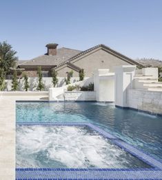 an outdoor swimming pool with steps leading up to it and a house in the background