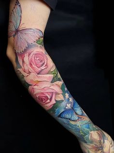 a woman's arm with flowers and butterflies on it