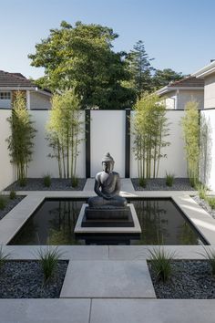 a small garden with a buddha statue in the center