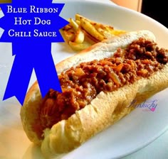 a chili dog on a plate with french fries and blue ribbon around the edges that says, blue ribbon hot dog chili sauce