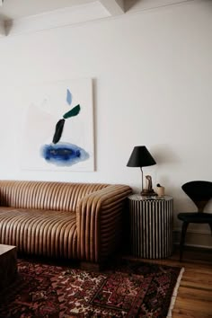 a living room filled with furniture and a painting on the wall