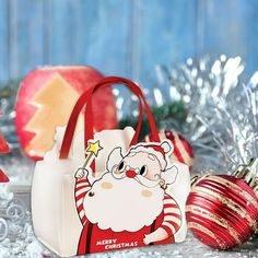 a santa clause bag sitting next to christmas ornaments