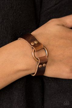 Shiny strips of brown leather loop around a shimmery copper hoop, creating an urban centerpiece. Features an adjustable snap closure. Sold as one individual bracelet. P9UR-CPXX-022XX Cheap Trendy Leather Bracelet For Parties, Cheap Casual Brown Leather Bracelet, 1mm Leather Cord Bracelet, Leather Wristbands Wrap, Adjustable Rivet Bracelets, Luxury Leather Bracelets With Brass Hardware, Casual Everyday Affordable Leather Bracelet, Clasps For Leather Bracelets, Stamped Leather Bracelets