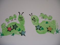 two children's handprints made to look like green caterpillars