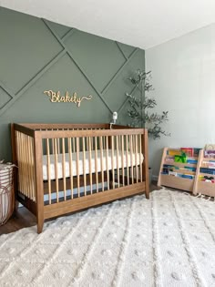 a baby's room with a crib, bookcase and toy bins