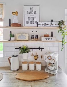 a kitchen counter with coffee maker and cups on it