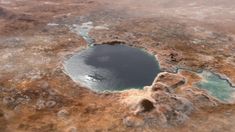 an aerial view of a lake surrounded by land and water in the middle of nowhere