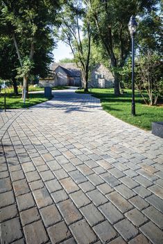 a brick walkway in the middle of a park