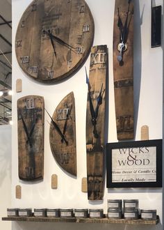 several wooden clocks mounted to the side of a wall