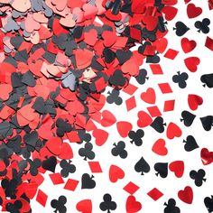 red and black hearts are scattered on a white background