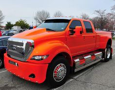 an orange truck parked in a parking lot