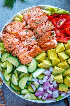 salmon and cucumber salad in a white bowl