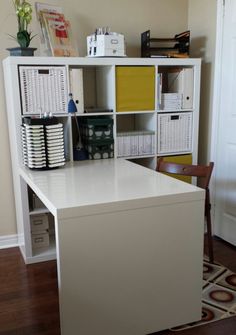 a white desk sitting in the middle of a room