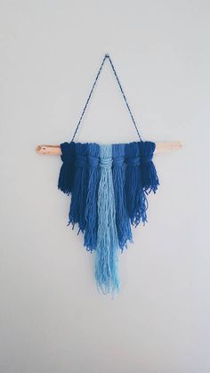 a blue wall hanging with fringes on it