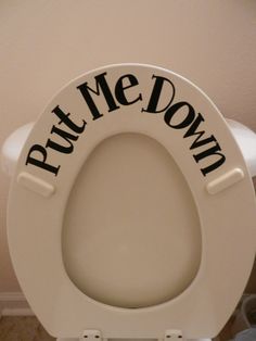 a white toilet with the words put me down on it's seat and lid