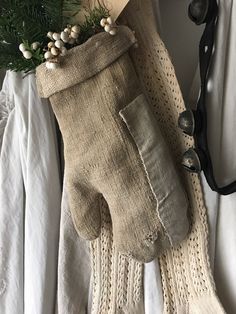 an old pair of gloves is sitting on a bed next to a book and sunglasses