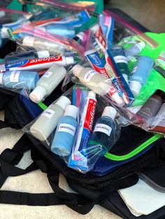 a bag filled with lots of different types of toothbrushes and mouthpaste