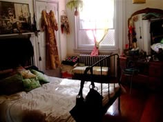 a bed room with a neatly made bed next to a window