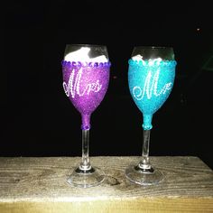 two wine glasses with the word mr and mrs painted on them sitting side by side