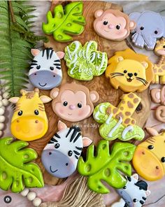 the cookies are decorated with different animals and plants on them, including zebras, giraffes, elephants, and more