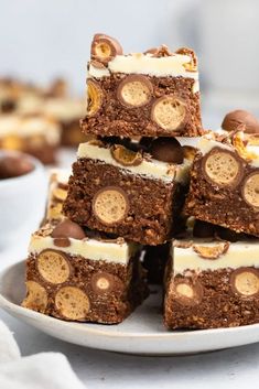 a white plate topped with brownies and marshmallows on top of each other