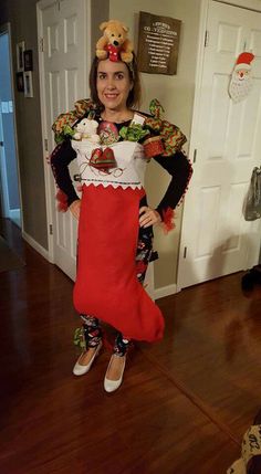 a woman in a christmas stocking costume standing on the floor with her hands on her hips