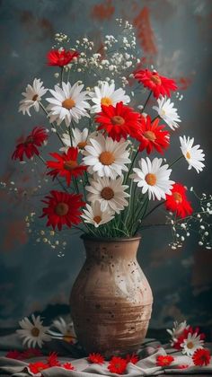 a vase filled with lots of white and red flowers