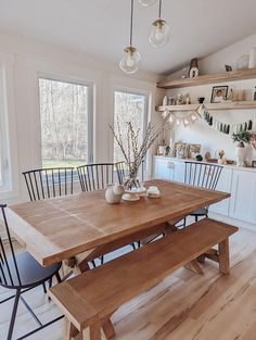 a wooden table sitting in the middle of a kitchen