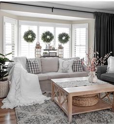 the living room is decorated with wreaths and other things in white, black and gray