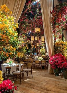 the interior of a restaurant decorated with flowers