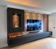 a flat screen tv mounted to the side of a wall next to a fire place