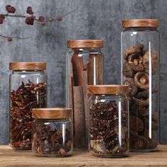 several glass jars filled with different types of spices