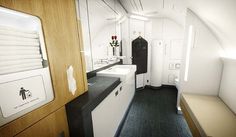 an airplane bathroom with black and white flooring